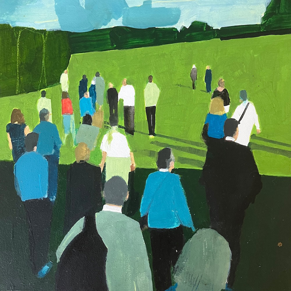 Audience members heading across the lawn