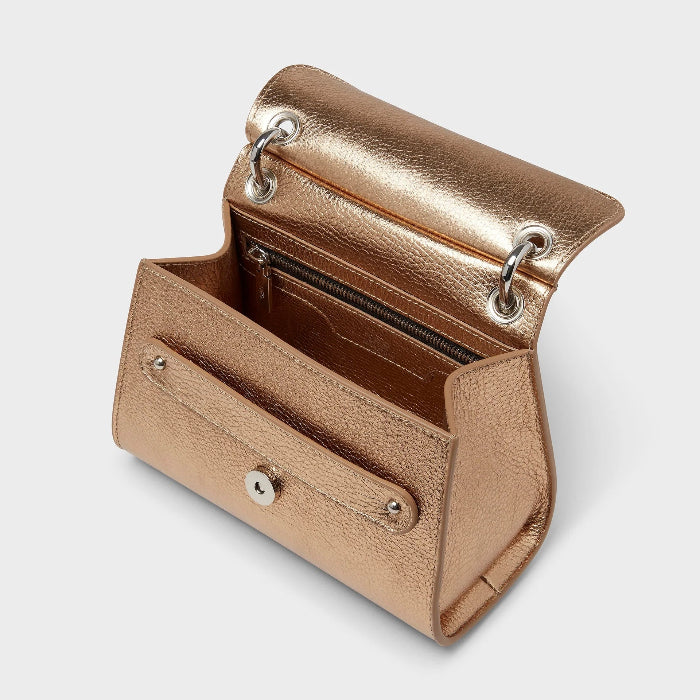 Gold handbag with a silver clasp on a light gray background