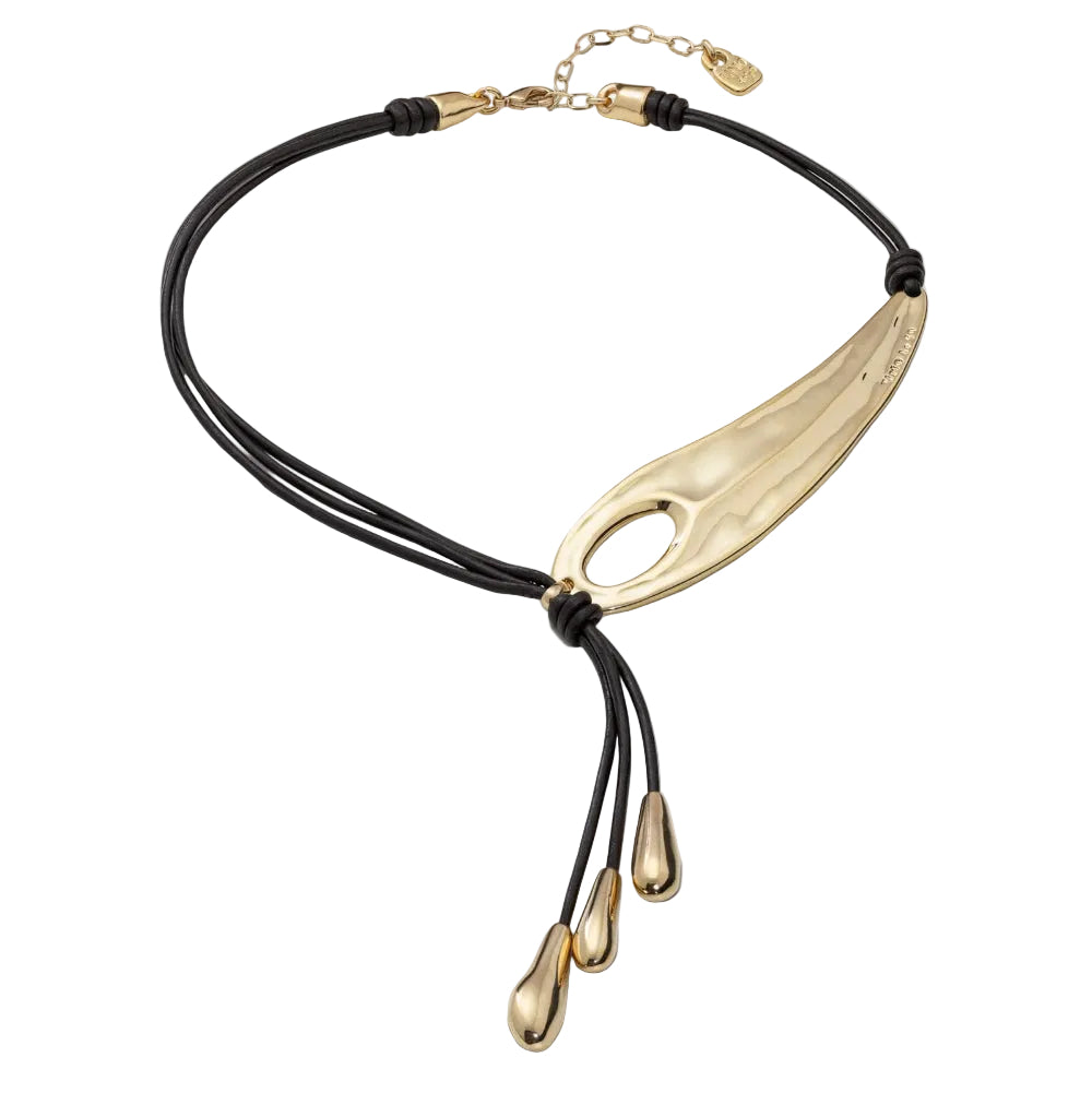 Necklace with a large gold pendant and black cord on a white background
