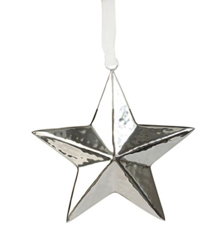 A hammered silver metal star-shaped Christmas ornament with a white hanging ribbon, shown against a plain white background.