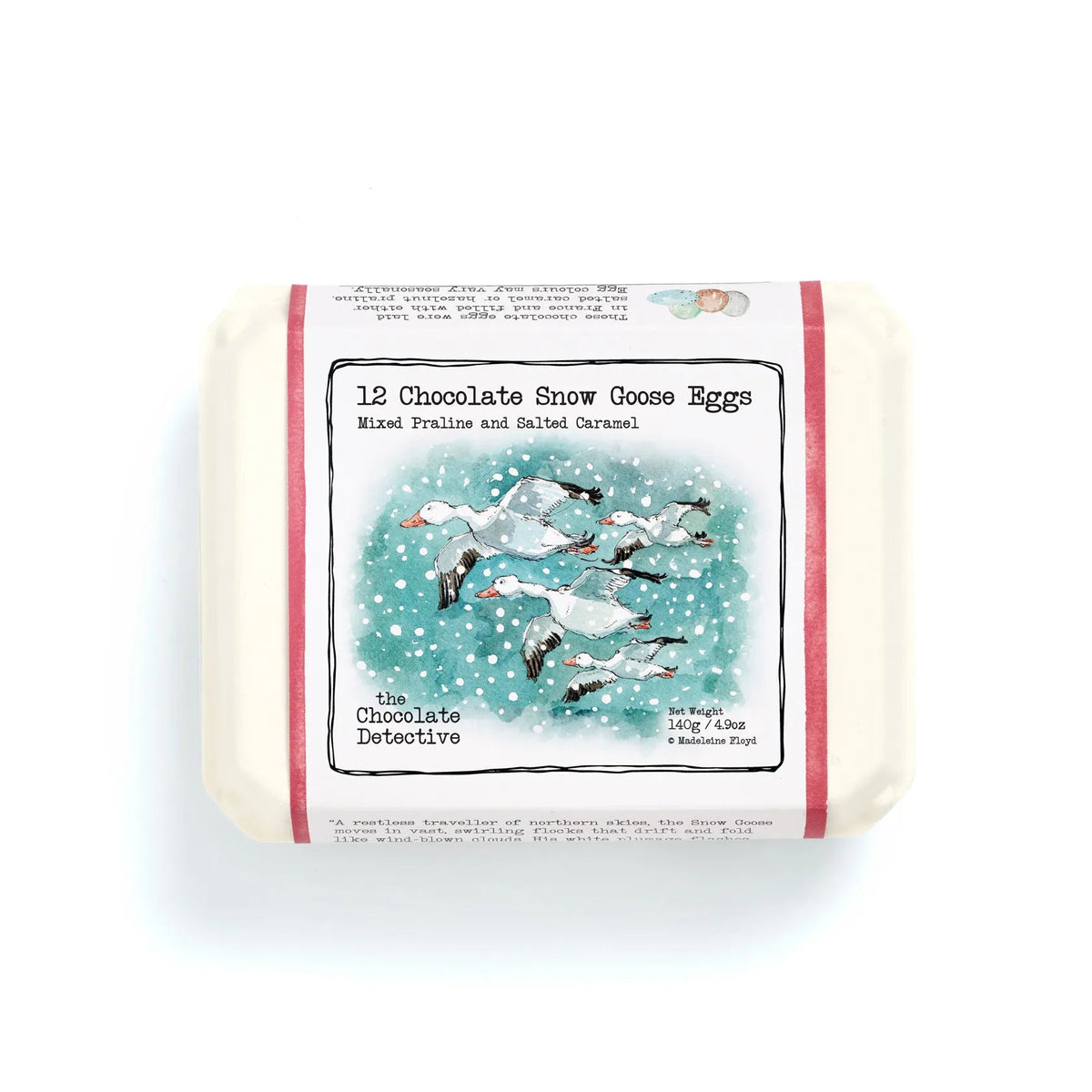 A packaged bar of soap labeled '12 Chocolate Snow Goose Eggs' with an illustrated winter scene of snow geese on a teal-blue snowy background. The soap itself is off-white, and the label has red side borders.