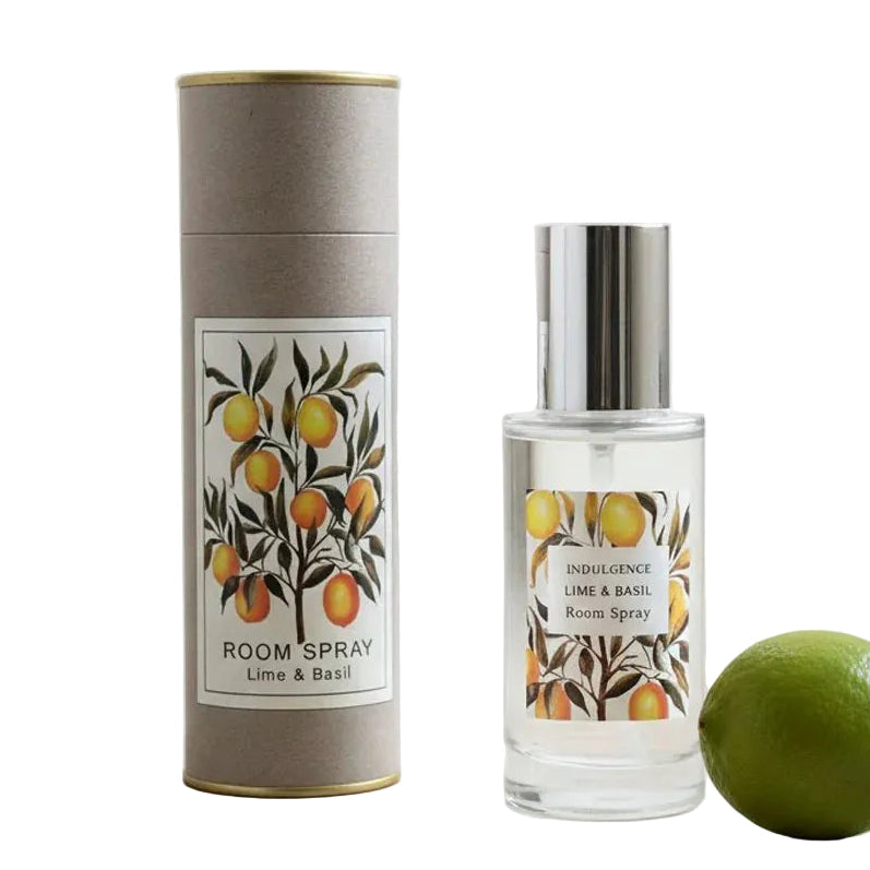 Room spray bottle and cylindrical container with lime and basil design on a light surface.